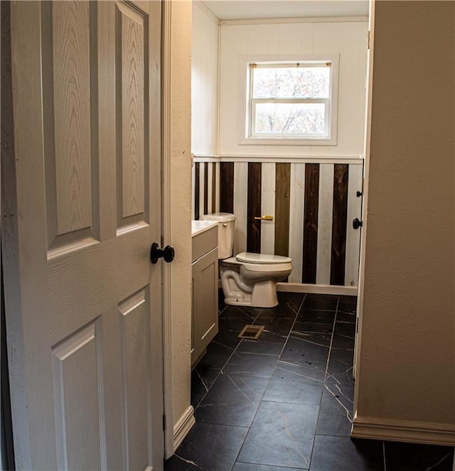 bathroom featuring vanity and toilet