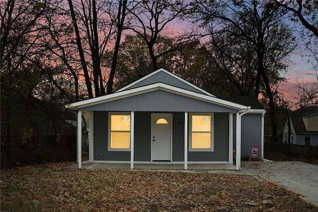 outdoor structure at dusk featuring a porch