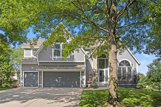 view of front facade with a front lawn and a garage