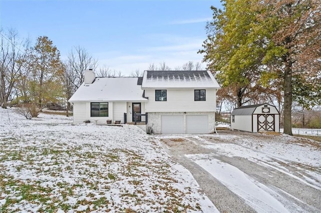 view of front of home featuring a shed and a garage