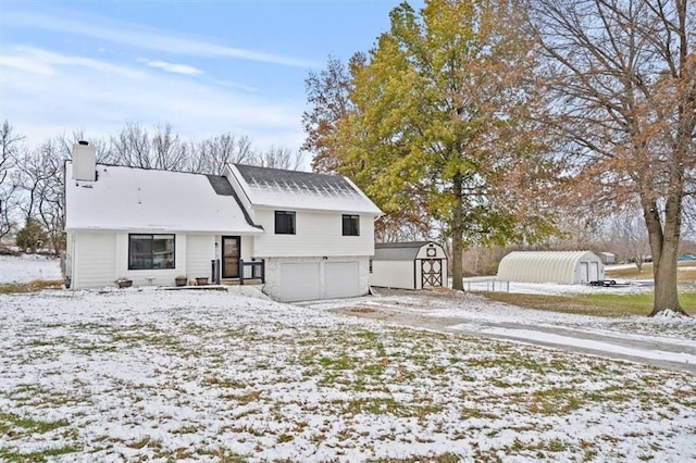 snow covered house with a storage unit