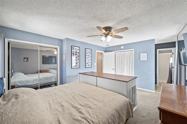 carpeted bedroom with ceiling fan and a textured ceiling