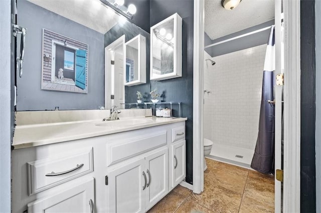 bathroom with toilet, vanity, a textured ceiling, and a shower with curtain