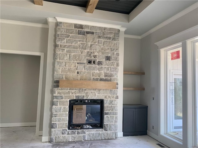 room details with visible vents, a fireplace, crown molding, and baseboards