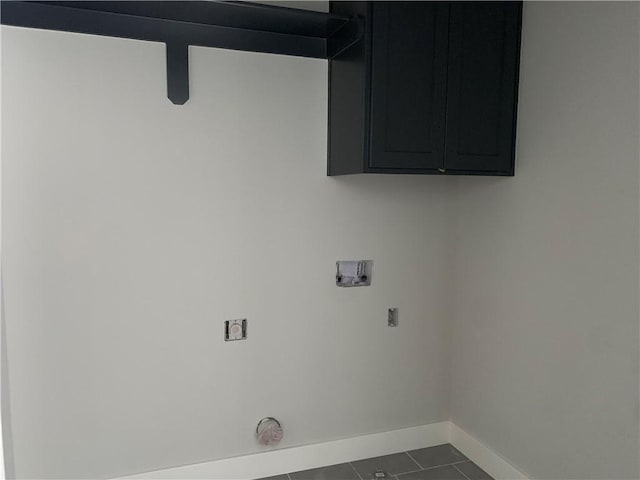 washroom with baseboards, cabinet space, washer hookup, and tile patterned flooring