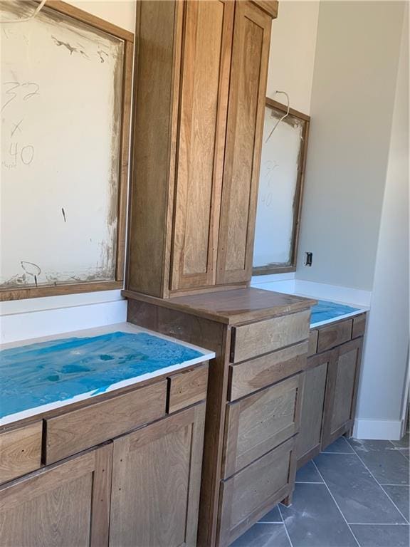 bathroom with tile patterned floors and baseboards