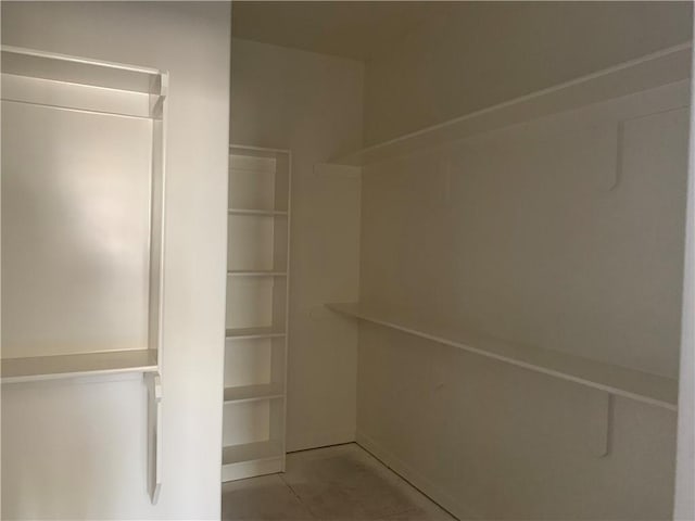 spacious closet with tile patterned flooring