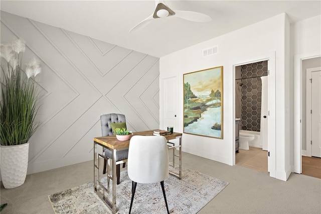 dining room featuring visible vents, carpet floors, and ceiling fan