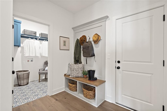 mudroom featuring baseboards and wood finished floors