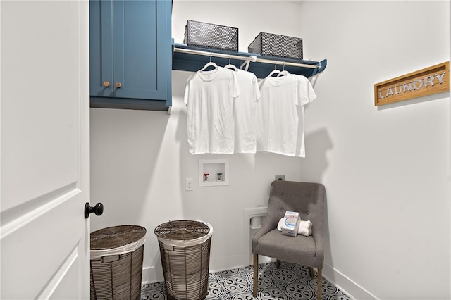 clothes washing area featuring tile patterned flooring, hookup for a washing machine, cabinet space, and baseboards