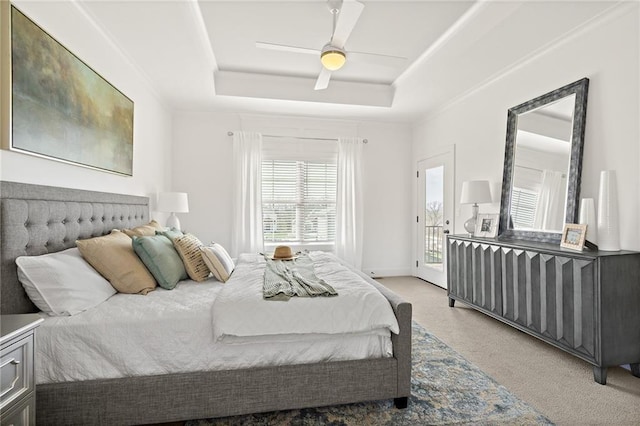 bedroom featuring baseboards, ceiling fan, access to exterior, a raised ceiling, and light colored carpet