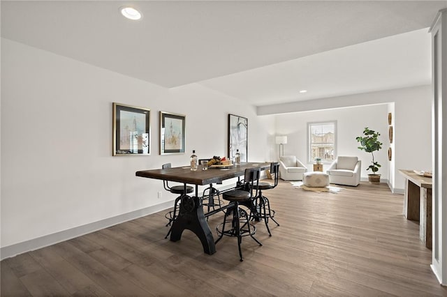 dining room with recessed lighting, baseboards, and wood finished floors