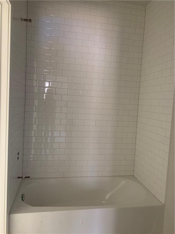 bathroom with shower / washtub combination