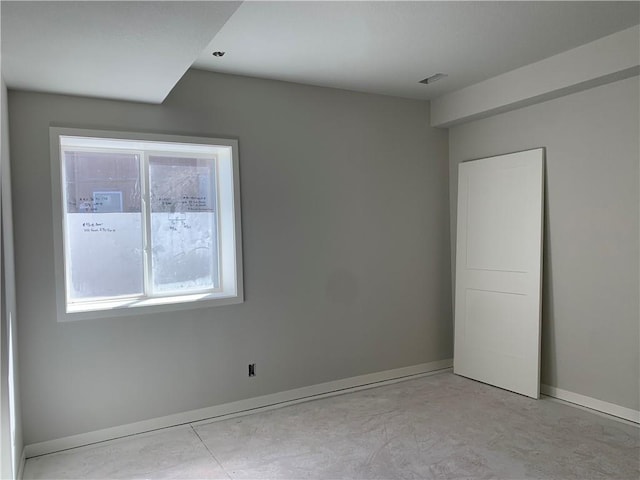 unfurnished room with visible vents, baseboards, and concrete floors