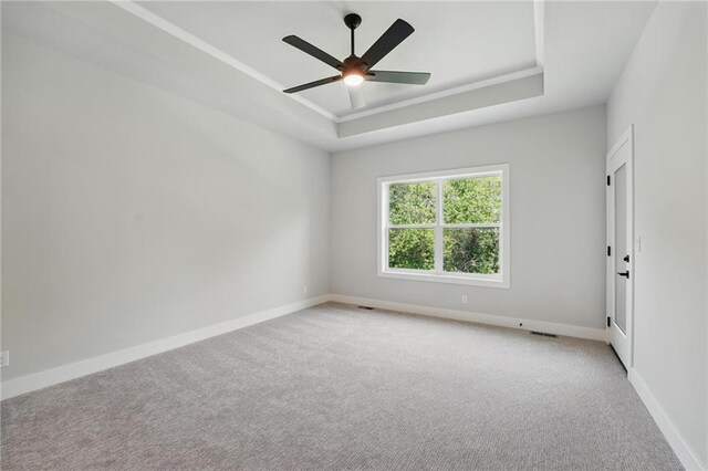 1406 NW 106th Ter, Kansas City, MO 64155 - empty room featuring carpet flooring, a raised ceiling, and ceiling fan