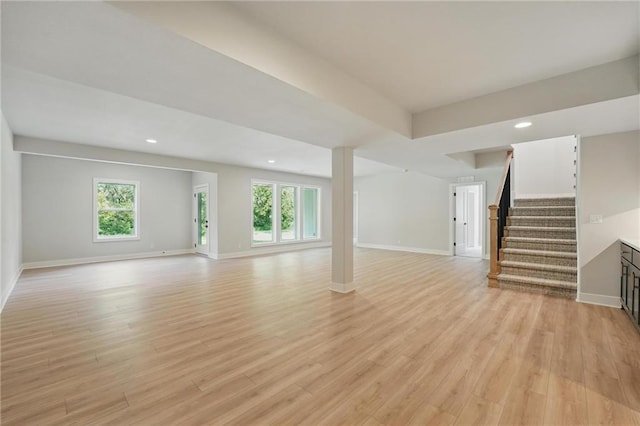 1406 NW 106th Ter, Kansas City, MO 64155 - unfurnished living room featuring stairs, light wood-style flooring, recessed lighting, and healthy amount of natural light