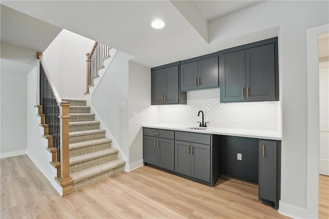1406 NW 106th Ter, Kansas City, MO 64155 - bar with light wood-style floors, backsplash, stairs, and recessed lighting