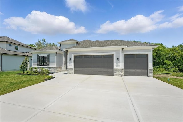 1406 NW 106th Ter, Kansas City, MO 64155 - prairie-style home featuring an attached garage, stone siding, concrete driveway, and a front yard