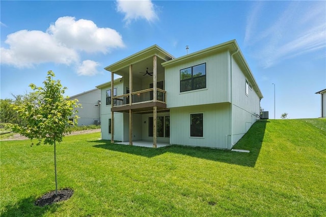 1406 NW 106th Ter, Kansas City, MO 64155 - back of property with a balcony, ceiling fan, a patio area, and a lawn