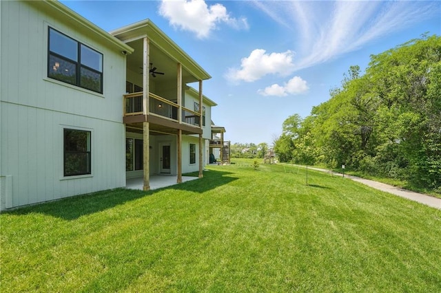 1406 NW 106th Ter, Kansas City, MO 64155 - view of green lawn featuring a ceiling fan, a balcony, and a patio