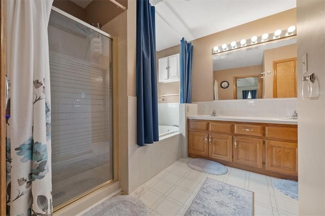 full bathroom with tasteful backsplash, a shower stall, tile patterned floors, a bath, and vanity