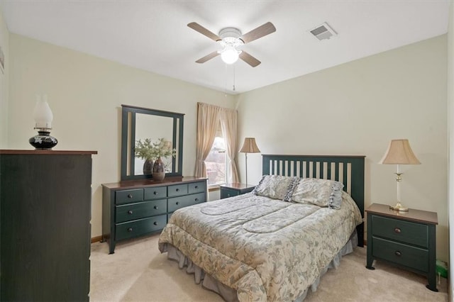 bedroom with a ceiling fan, light colored carpet, and visible vents