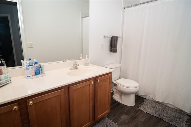 bathroom with vanity, wood-type flooring, and toilet