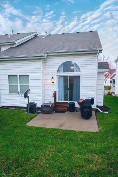 back of house featuring a yard and a patio area