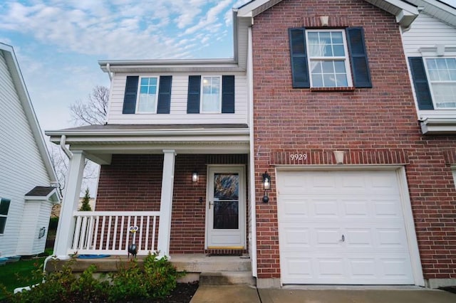 view of front of house featuring a porch and a garage