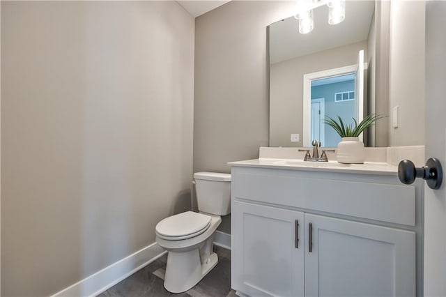 bathroom featuring vanity and toilet