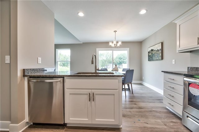 kitchen featuring an inviting chandelier, white cabinets, sink, light hardwood / wood-style flooring, and stainless steel appliances