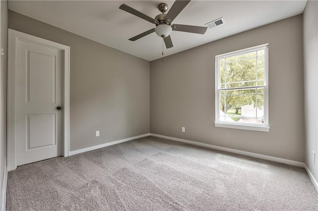 empty room featuring light colored carpet and ceiling fan