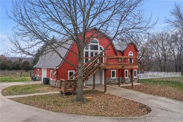 view of front of property with central AC, a garage, and a deck