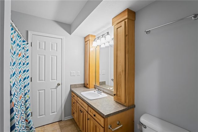 bathroom featuring tile patterned floors, vanity, and toilet