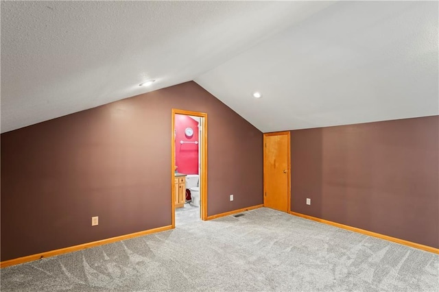 bonus room with carpet floors and lofted ceiling