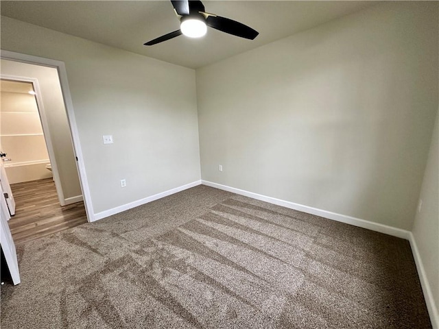 unfurnished room featuring ceiling fan and carpet floors