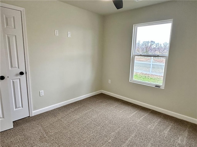 unfurnished room with ceiling fan and carpet floors