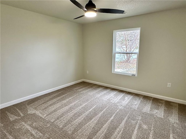 empty room featuring carpet and ceiling fan