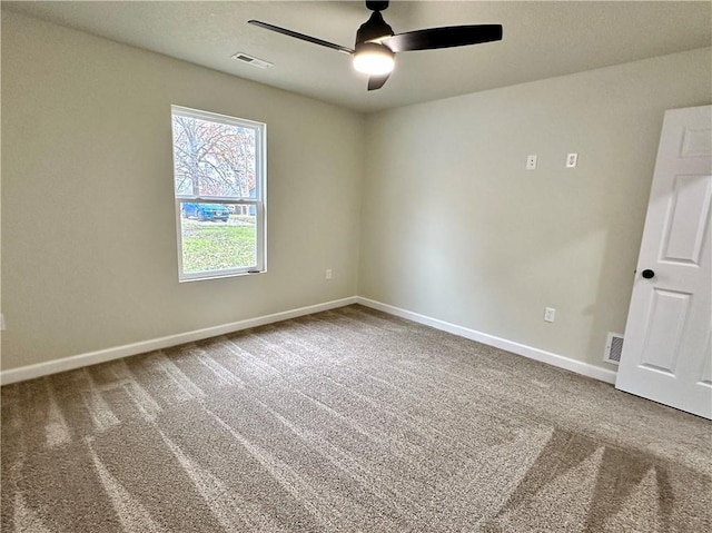 carpeted spare room featuring ceiling fan