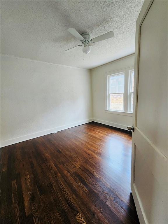 spare room featuring ceiling fan, dark hardwood / wood-style floors, and a textured ceiling