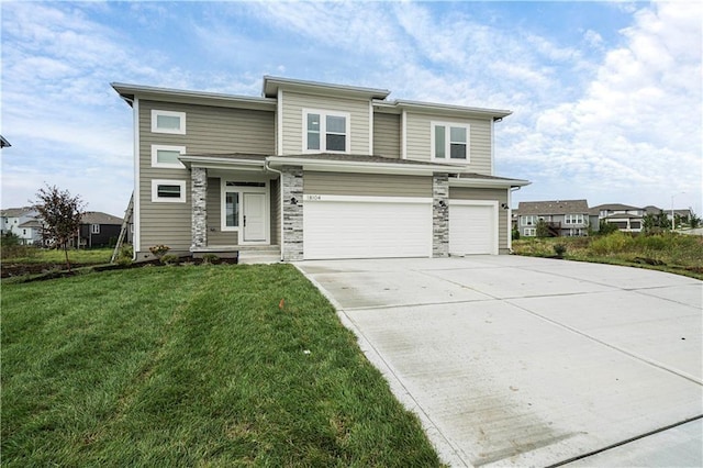 11115 N Glenwood Ave, Kansas City, MO 66157 - prairie-style house featuring an attached garage, concrete driveway, a front yard, and stone siding