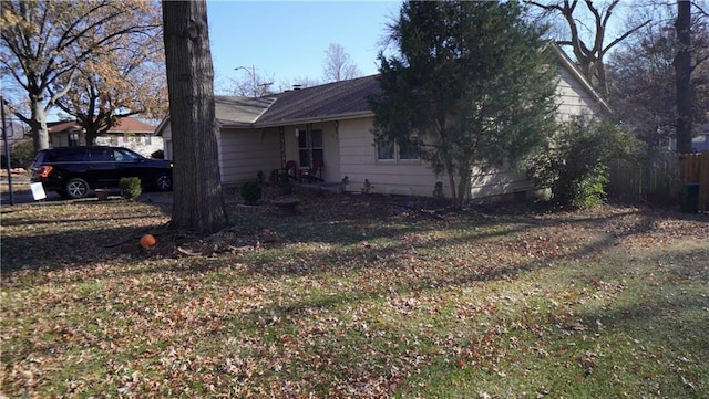 view of side of property with a lawn