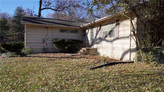 view of property exterior featuring a lawn