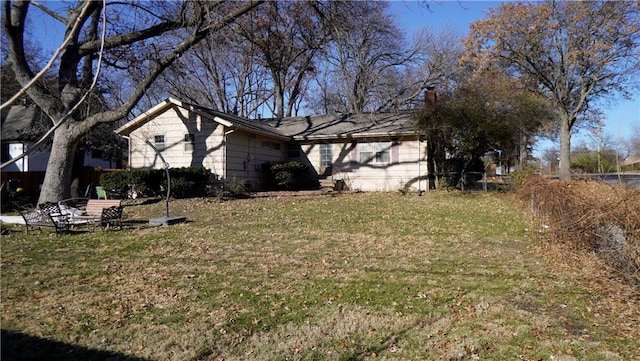 view of property exterior featuring a lawn