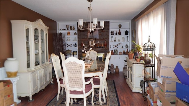 dining room with dark hardwood / wood-style floors and an inviting chandelier