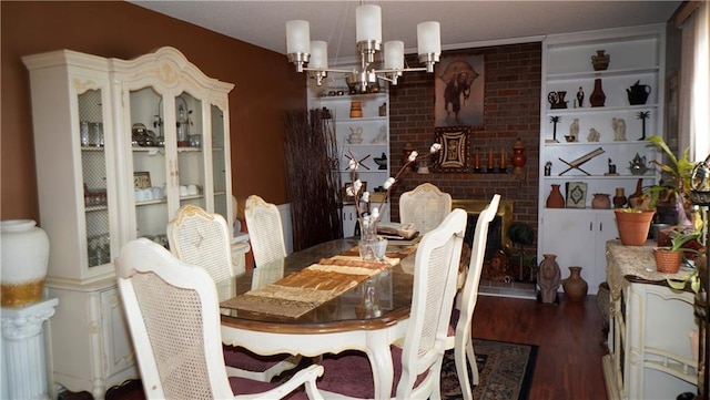 dining room with dark wood-type flooring and an inviting chandelier