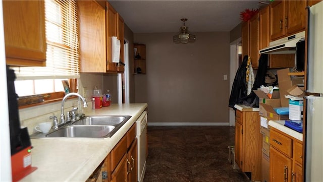 kitchen with tasteful backsplash, sink, and white dishwasher