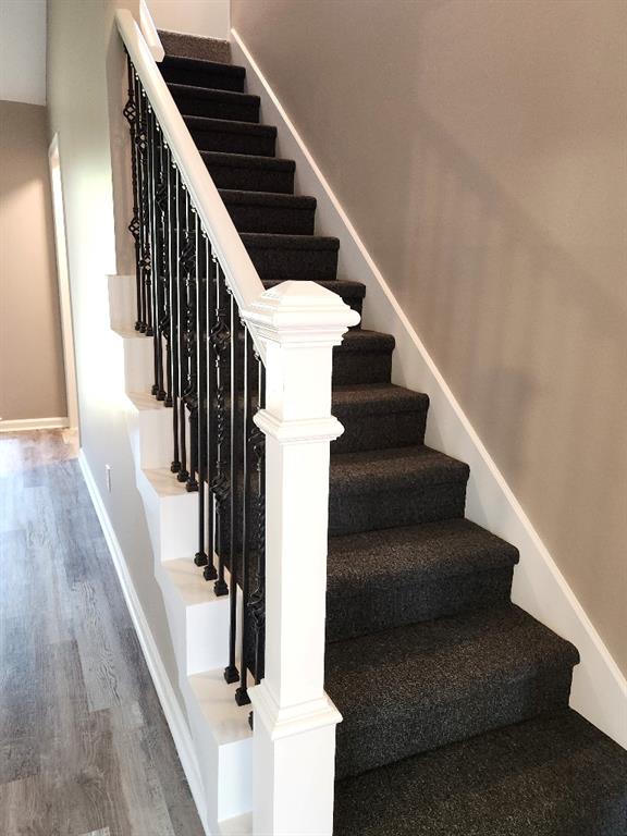 stairs featuring hardwood / wood-style flooring