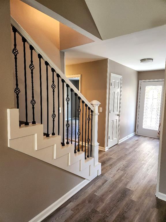 stairs featuring hardwood / wood-style flooring