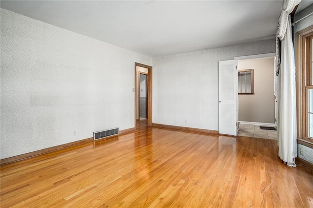 spare room with hardwood / wood-style flooring